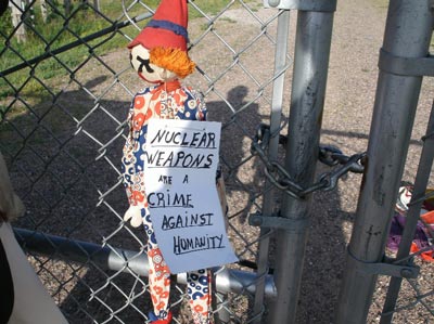 Nuclear weapons are a crime against humanity. Carl Kabat puts clown and sign on N-8 Minuteman III missile silo, August 8, 2009